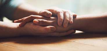 Holding someone's hand in a supportive way